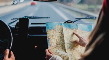 Pessoas dentro do carro com mapa de viagem